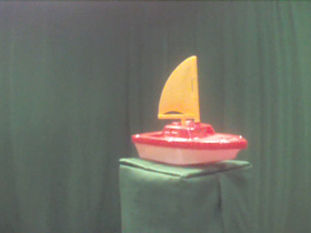 315 Degrees _ Picture 9 _ Red and Yellow Toy Sailboat.png